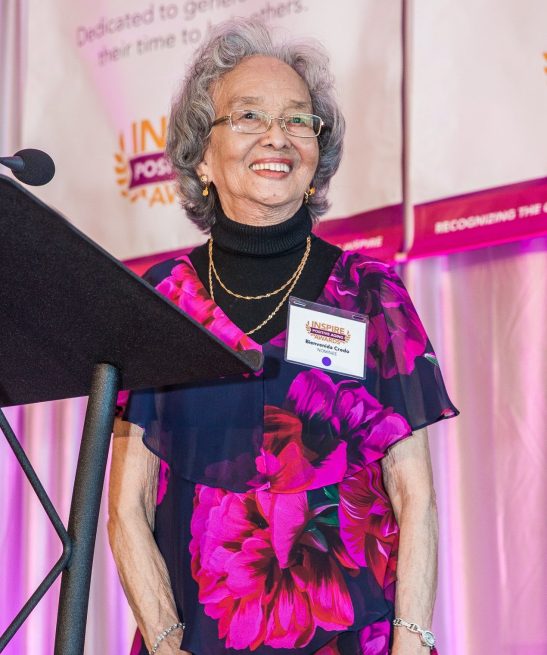 I Inspire poster for the Inspire Positive Aging Awards featuring a smiling woman at a pedestal, recognizing her weekly service to older adults in King County as an AmeriCorps Senior Companion with VOA and later Homage