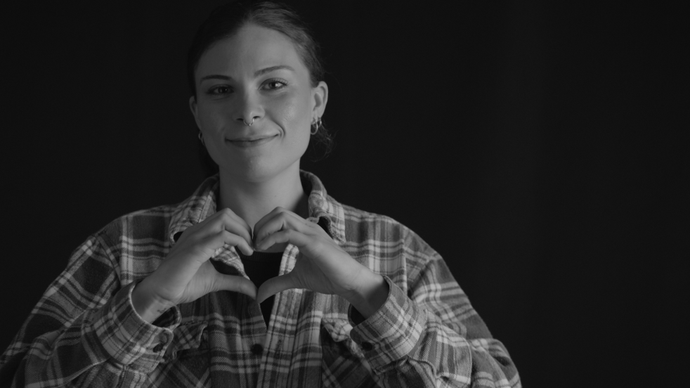 Smiling woman holding her hands in a heart shape to her chest, with the caption “Pathways Information & Assistance,” highlighting Sound Generations’ commitment to mental health and connecting older adults to essential resources through Assistance Services and Health & Wellness programs in the Greater Seattle Area