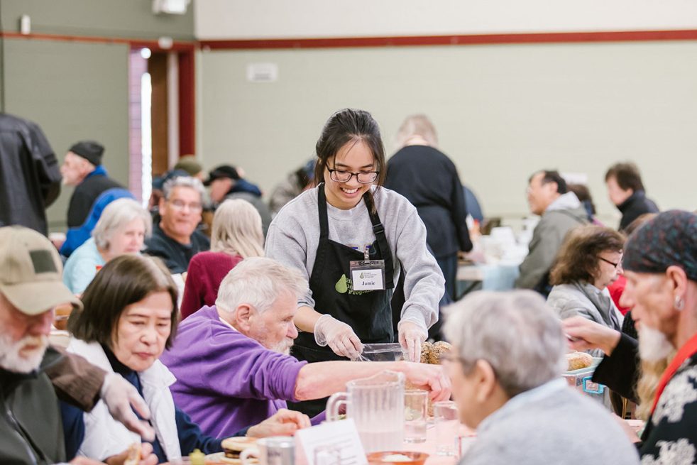 woman in apron serving food