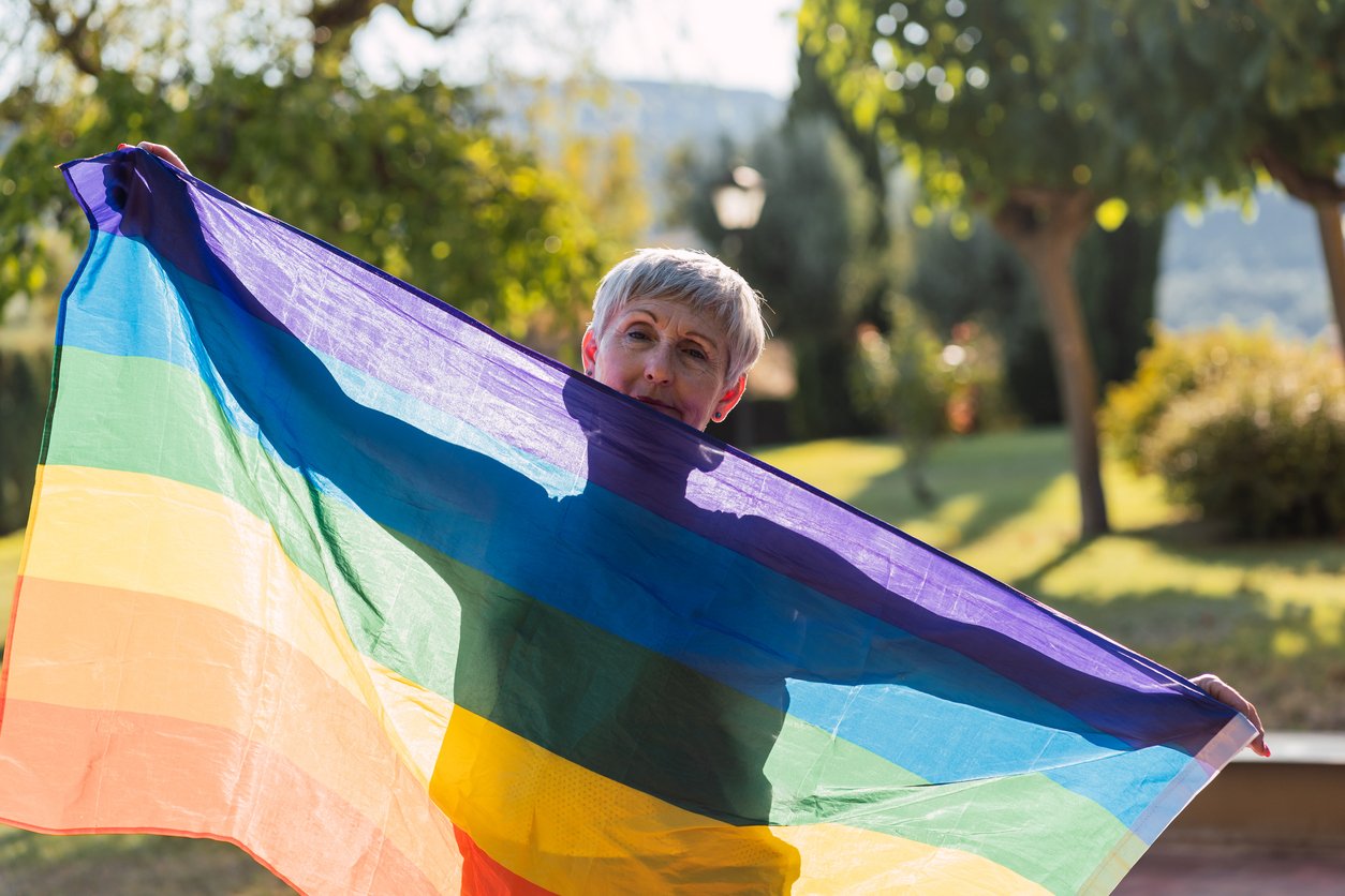 older woman with pride flag